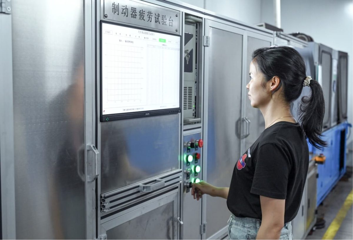 Engineer operating a brake caliper test bench